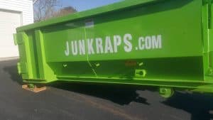 Dumpster rental container at Abrams Landing, positioned for residential or construction waste disposal.